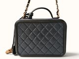 a black quilted leather handbag with a chain strap