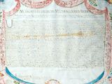 an old book with a very large piece of writing on top of it