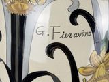 a vase with a floral design on it on a table