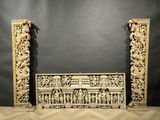 a pair of carved wooden columns with carvings on them