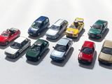 several toy cars are lined up in a row on a white surface