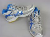 pair of silver and blue tennis shoes on a white surface