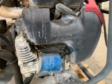 a close up of a motorcycle engine on a wooden pallet