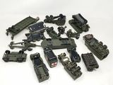 a lot of toy army vehicles that are on a table