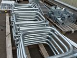 a lot of metal pipes that are sitting on a pallet