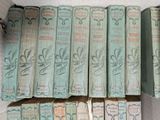 several old books are stacked on top of each other on a table