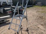 a ladder that is sitting on the ground next to a truck