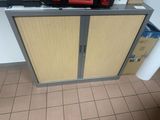 a small cabinet with two doors and a red fire hydrant on top of it