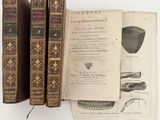 two old books are sitting on a table next to each other