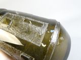 a person holding a bottle of liquid with a knife in it