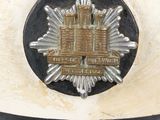 a white hat with a black and gold emblem on it
