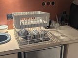 a kitchen with a sink, dishwasher, and refrigerator