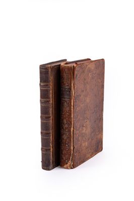 an old book is open on a white surface with a white background