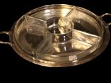 a silver tray with a candle on it on a black background