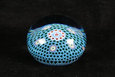 a glass ball with a pattern on it on a black surface