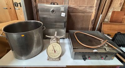 a large pot on a table with a scale on it