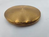 an image of a gold plated pocket watch on a white surface