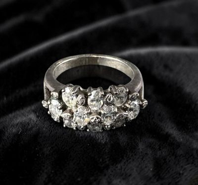 a close up of a diamond ring on a black cloth