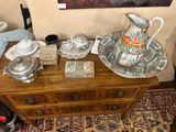 a wooden table with a tea pot and other items on it
