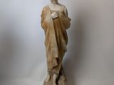marble statue of a woman holding a book
