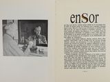an open book with a picture of a man and a woman sitting at a table