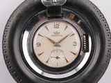 a close up of a watch with a chain around it