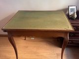 a small table with a green top in a living room