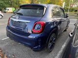 a blue car that is parked in a parking lot
