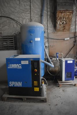 a blue machine sitting in a room next to a blue machine