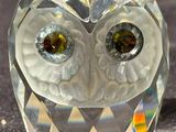 crystal figurine of an owl sitting on a black cloth