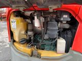 a red truck with a bunch of gas cans inside of it