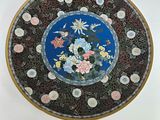 a plate with flowers on it sitting on a table