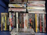 a lot of dvds on a blue shelf in the room