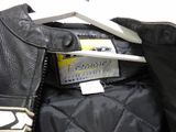 a black leather jacket with a white tag on it