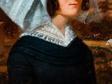 portrait of a woman in a blue bonnet with a bird in her hand