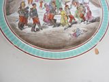 a plate with a picture of a group of people on it