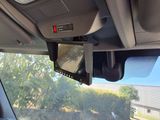 dashboard view of a car with a rear view mirror and a dash camera