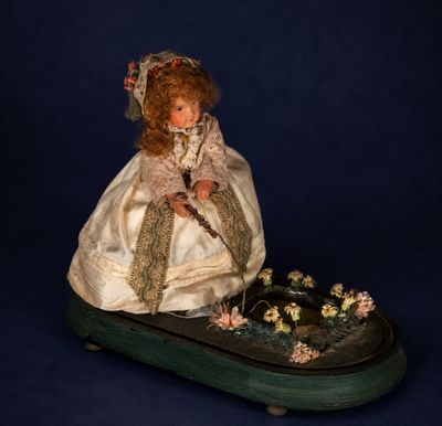 a doll that is sitting on top of a box