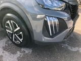 the front end of a silver suv parked in a parking lot