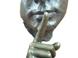 statue of a man with a finger on his lips