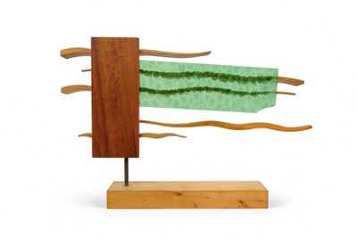 sculpture of a piece of wood with a piece of green fabric on it