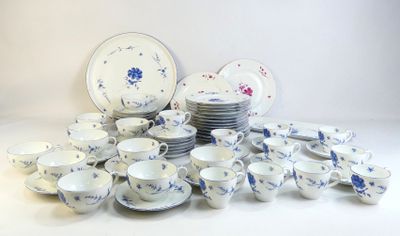 a lot of plates and cups sitting on a table