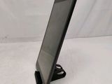 a tablet computer sitting on a stand on a white surface