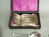 many spoons and spoons in a box with a pink cover