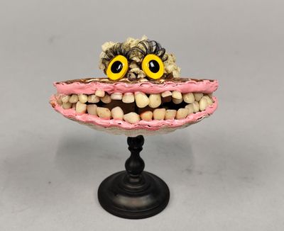 un gâteau surélevé, orné d'un visage composé de brosses à dents