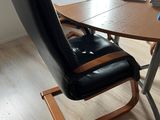 a desk with a chair and a laptop on it