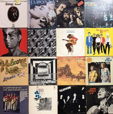 a lot of records on the wall of a room