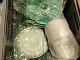 many pieces of glass in a container on the table