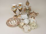 many different types of porcelain dishes and vases on the table