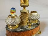 an image of a gold and glass candle holder on a marble base